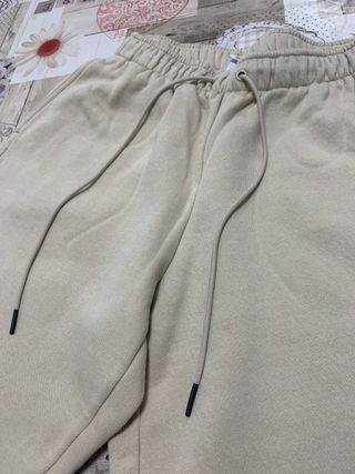 Calças Nike bege com swoosh branco