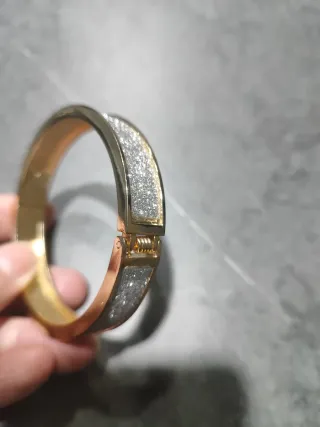 Pulsera dorada con detalles plateados