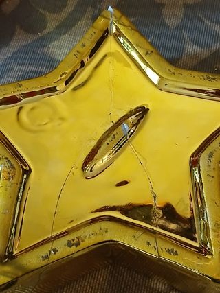 Due portacandele con forma di campana e stella