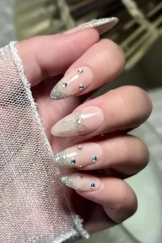 Uñas acrílicas decoradas con glitter y pedrería
