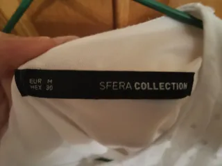 Blusa blanca con topos brillantes M