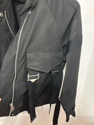 Chaqueta técnica negra con correas y hebillas