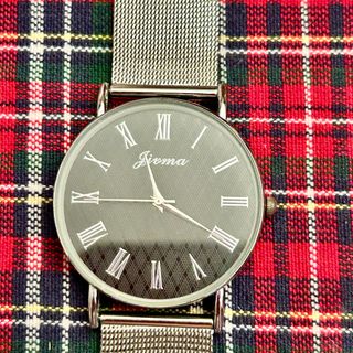 Reloj de bisutería color plateado y esfera negra.