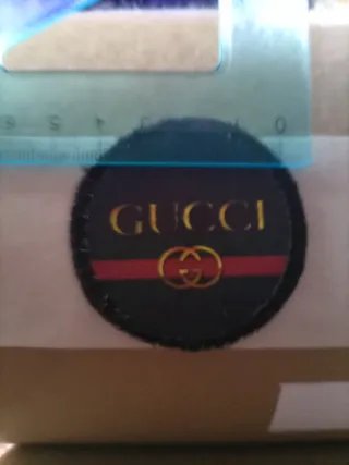 Toppa Gucci nera e oro