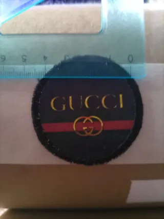 Toppa Gucci nera e oro