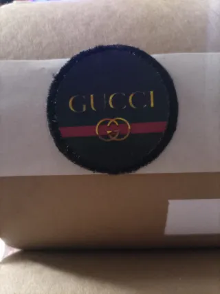 Toppa Gucci nera e oro
