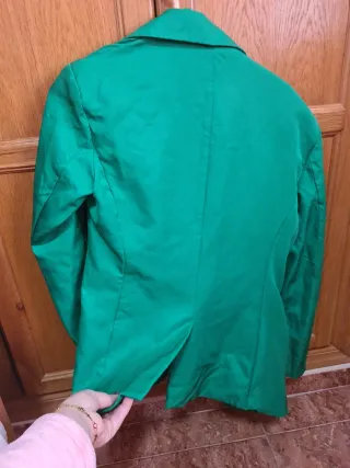 Blazer verde tiene hombreras y forro