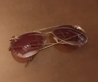 Gafas de sol rosas con montura dorada de palmeras