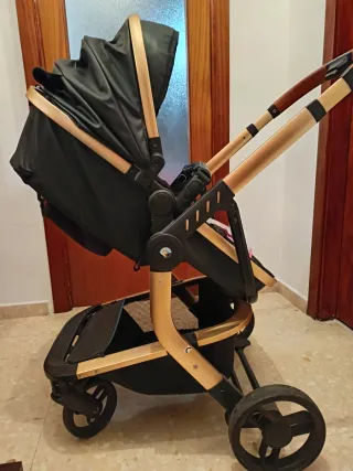 Carrito bebé negro y dorado
