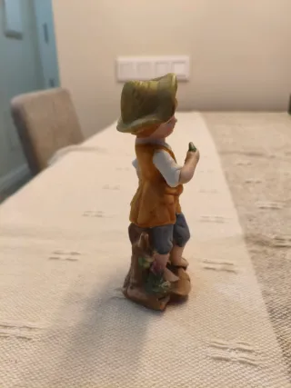 Figura niño recogiendo uvas