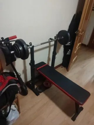 Press de banca con barra y discos