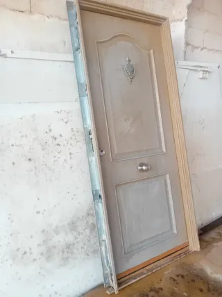 Puerta de madera con aldaba y pomo