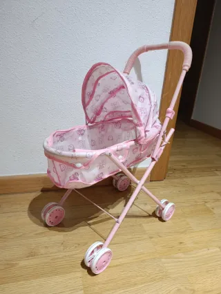 Cochecito de bebé de juguete rosa