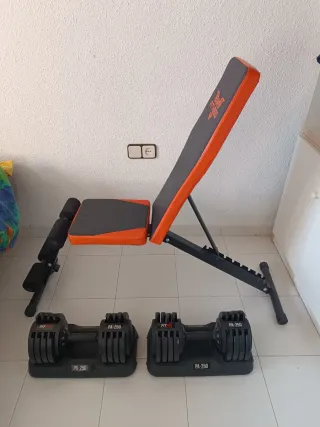 Banco de pesas ajustable naranja y negro.