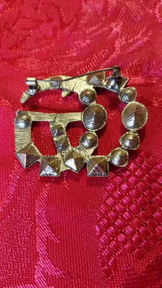 Spilla Gucci oro con pietre colorate