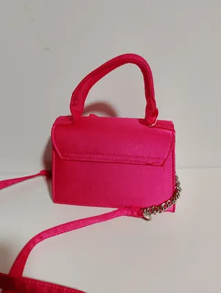Bolso rosa con lazo y pedrería