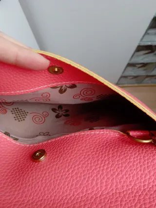 Bolso de mano rosa con cadena dorada