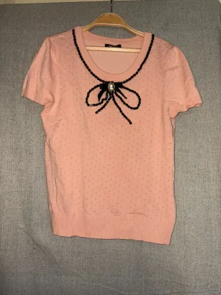 Camiseta rosa con lazo y camafeo