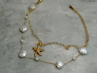 Bracciale acciaio con stelle marine e conchiglie