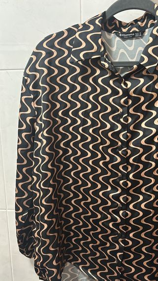 Blusa ondas negro y dorado