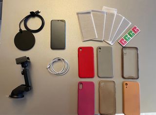 iPhone XR bianco e accessori (supporto e caricatore)