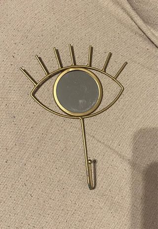 Colgador ojo dorado con espejo