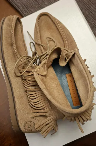 Mocasines piel vacuno beige cordones y flecos.