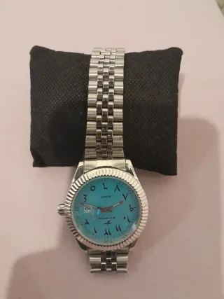 Reloj de pulsera turquesa y plateado