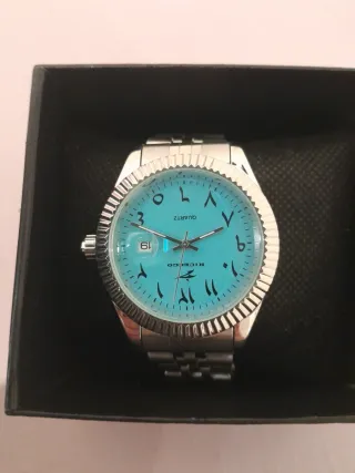 Reloj de pulsera turquesa y plateado