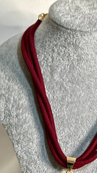 Colar com pingente de dente de ouro e vermelho