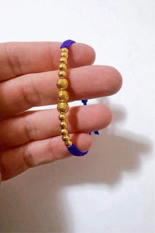 Bracciale in stoffa con sfere in oro giallo 18kt