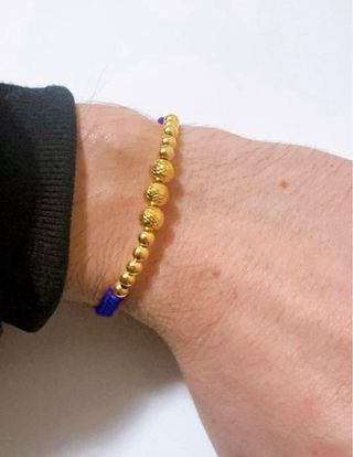 Bracciale in stoffa con sfere in oro giallo 18kt