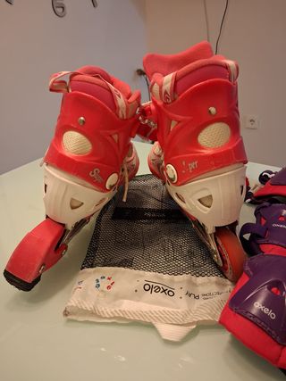 Pattini a rotelle rosa e bianchi con protezioni