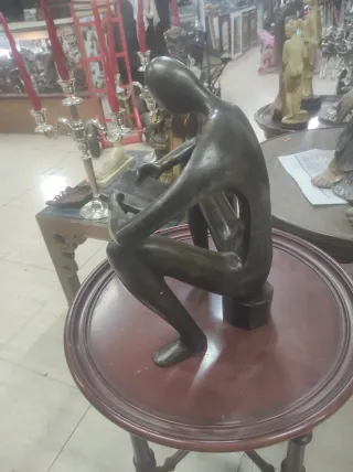 Figura de bronce de hombre leyendo