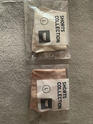 Tanga negro, blanco y rosa con detalle dorado.