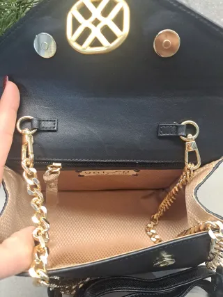 Bolso negro con logo dorado