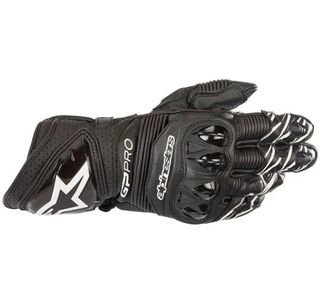 Mono, botas, espaldera y guantes de moto.