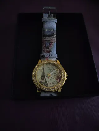 Reloj dorado con esfera de Torre Eiffel