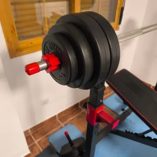 Banco de pesas con barra y discos