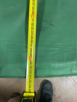 Cama elástica verde con red de seguridad