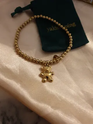 Pulsera dorada con charm de oso