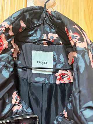 Plumífero negro con flores rosas