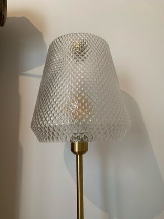 Lámpara de pie dorada y transparente