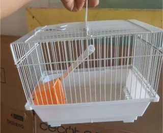 Jaula para pájaros blanca y naranja