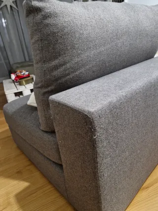 Sillón de tela gris con cabezal reclinabe