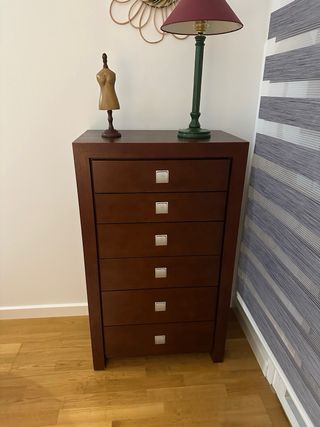 Cómoda de madera marrón y dos mesitas.