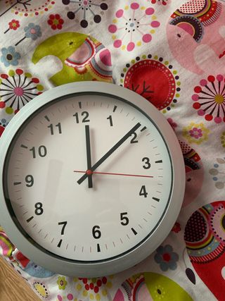 Reloj de pared plateado y blanco