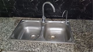 Fregadero doble con grifos de metal