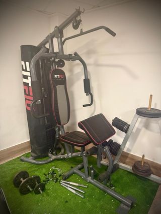 Banco de pesas con barra y discos