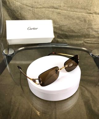 Occhiali da sole Cartier dorati marroni